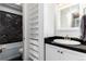 Bathroom featuring a black marble wall and built-in shelving at 1270 N Marion St # 505, Denver, CO 80218