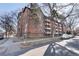 Brick apartment building with multiple balconies on a street with parked cars at 1270 N Marion St # 505, Denver, CO 80218