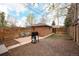 Cozy backyard features a brick patio, barbecue grill, and wood fence, perfect for outdoor entertaining and relaxation at 3700 Zenobia St, Denver, CO 80212