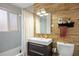 Modern bathroom featuring wood paneled walls, sleek vanity, and shower with curtain at 3700 Zenobia St, Denver, CO 80212