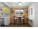 Cozy dining area features exposed brick, a window view, and stylish decor at 3700 Zenobia St, Denver, CO 80212