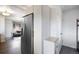 Convenient entryway near a stainless steel refrigerator, storage and coat hooks at 3700 Zenobia St, Denver, CO 80212