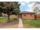 Charming brick home with a well-manicured lawn and mature tree at 3700 Zenobia St, Denver, CO 80212