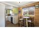 Eat-in kitchen showcasing updated cabinetry, stainless steel appliances, and a stylish breakfast nook at 3700 Zenobia St, Denver, CO 80212