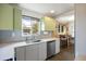 Updated kitchen features stainless steel appliances, sleek countertops, and a window offering natural light at 3700 Zenobia St, Denver, CO 80212