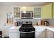 Well-lit kitchen with stainless steel appliances, modern cabinetry, and quartz countertops at 3700 Zenobia St, Denver, CO 80212