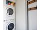 Efficient laundry room with stacked washer and dryer, plus built-in storage at 3700 Zenobia St, Denver, CO 80212