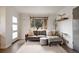 Sunlit living room featuring a comfortable sofa and a large window with neighborhood views at 3700 Zenobia St, Denver, CO 80212