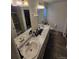 The bathroom features a double vanity, wood-look floors, and an enclosed shower at 18006 E 103 Ave, Commerce City, CO 80022