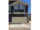 Exterior view of the home's garage, siding, and second story windows at 18006 E 103 Ave, Commerce City, CO 80022