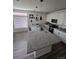 Modern kitchen featuring white cabinets, granite countertops, pendant lighting, and stainless steel appliances at 18006 E 103 Ave, Commerce City, CO 80022