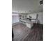 Open kitchen with granite island, bar stools, pendant lighting and stainless-steel appliances at 18006 E 103 Ave, Commerce City, CO 80022
