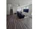 Bright living room featuring laminate flooring, large window and comfortable seating arrangements at 18006 E 103 Ave, Commerce City, CO 80022