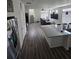 Spacious open-concept design with kitchen island, laminate flooring, and stairs in the background at 18006 E 103 Ave, Commerce City, CO 80022