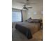 This room features a ceiling fan, neutral walls, and a large window with blinds at 18006 E 103 Ave, Commerce City, CO 80022