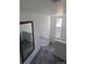 View of the carpeted staircase with natural light streaming in through the top-floor windows at 18006 E 103 Ave, Commerce City, CO 80022