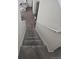 A view from the top of the carpeted staircase looking down to the wood floor entry at 18006 E 103 Ave, Commerce City, CO 80022