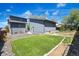 A spacious backyard showing a detached garage, fenced-in grass yard, and patio area at 5470 Krameria St, Commerce City, CO 80022