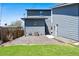 The backyard shows the house and detached garage, a patio and small fenced-in yard at 5470 Krameria St, Commerce City, CO 80022