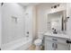 Modern bathroom features tiled shower and floor, updated vanity, and modern lighting at 5470 Krameria St, Commerce City, CO 80022