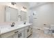 Bright bathroom with dual sinks, framed mirrors, and a shower at 5470 Krameria St, Commerce City, CO 80022