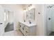 Modern bathroom features double sinks, framed mirrors, marble countertops, updated fixtures, and a separate shower at 5470 Krameria St, Commerce City, CO 80022