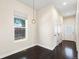 Bright bedroom features neutral walls, hard wood floors, and a modern fixture at 5470 Krameria St, Commerce City, CO 80022