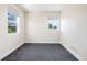 Bright bedroom features neutral walls, carpet, and two large windows at 5470 Krameria St, Commerce City, CO 80022