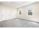Bright bedroom features neutral walls, carpet, and two large windows at 5470 Krameria St, Commerce City, CO 80022