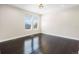 Bright bedroom features neutral walls, hard wood floors, and two large windows at 5470 Krameria St, Commerce City, CO 80022