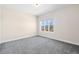 Bedroom featuring modern window with views, neutral paint and plush carpeting at 5470 Krameria St, Commerce City, CO 80022