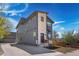 Modern two-story home featuring gray siding, stone accents, and a well-manicured front yard with a long driveway at 5470 Krameria St, Commerce City, CO 80022