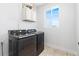Updated laundry room features modern washer and dryer, storage, and a bright window at 5470 Krameria St, Commerce City, CO 80022
