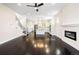 Bright, open living space with sleek hardwood floors, stairs, and views into the well-appointed kitchen at 5470 Krameria St, Commerce City, CO 80022
