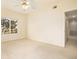 Bright bedroom features neutral carpeting, a ceiling fan, and a large window for natural light at 905 S Zeno Way # 204, Aurora, CO 80017