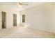 Neutral bedroom features an ensuite walk-in closet, a ceiling fan, and a window with natural light at 905 S Zeno Way # 204, Aurora, CO 80017