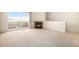 Spacious living room featuring a fireplace and sliding glass doors opening to a balcony at 905 S Zeno Way # 204, Aurora, CO 80017