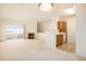 Bright, open living space with fireplace and view of kitchen and balcony at 905 S Zeno Way # 204, Aurora, CO 80017