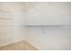 A simple walk-in closet features white walls and white wire shelving at 905 S Zeno Way # 204, Aurora, CO 80017