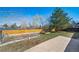 Well-kept backyard with garden beds, mature trees, a wooden fence, and a concrete patio at 9231 W Louisiana Ave, Lakewood, CO 80232