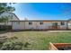Backyard featuring a well maintained lawn and neutral colored home exterior at 9231 W Louisiana Ave, Lakewood, CO 80232