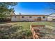 View of the backyard with flourishing green grass at 9231 W Louisiana Ave, Lakewood, CO 80232