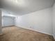 This finished basement has neutral carpet and white walls at 9231 W Louisiana Ave, Lakewood, CO 80232