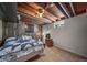 A cozy basement bedroom features wood accents, a star-patterned quilt, and a well-lit, inviting space at 9231 W Louisiana Ave, Lakewood, CO 80232