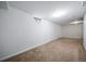This is a basement with white walls and a carpeted floor at 9231 W Louisiana Ave, Lakewood, CO 80232