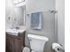 This bathroom has a white toilet, vanity, mirror, and light fixture at 9231 W Louisiana Ave, Lakewood, CO 80232
