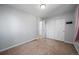The bedroom has neutral carpet, a large closet and white walls at 9231 W Louisiana Ave, Lakewood, CO 80232