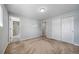 Bedroom with neutral walls, carpet, with access to ensuite bathroom and closet at 9231 W Louisiana Ave, Lakewood, CO 80232