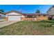Charming single-story home with a two-car garage, brick accents, and a well-maintained lawn at 9231 W Louisiana Ave, Lakewood, CO 80232