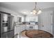 Bright kitchen with stainless steel refrigerator, white cabinetry, and tiled flooring at 9231 W Louisiana Ave, Lakewood, CO 80232